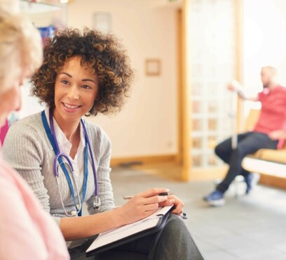 Caucasian senior female patient consulting a middle age african female doctor