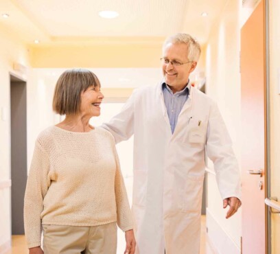 Senior caucasian doctor talking with his senior caucasian female patient