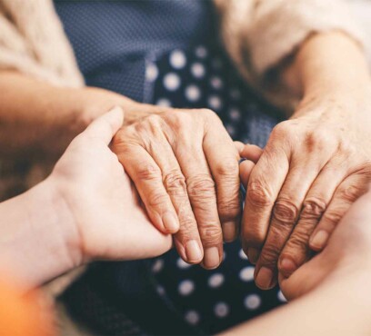 Doctor holding patient's hands